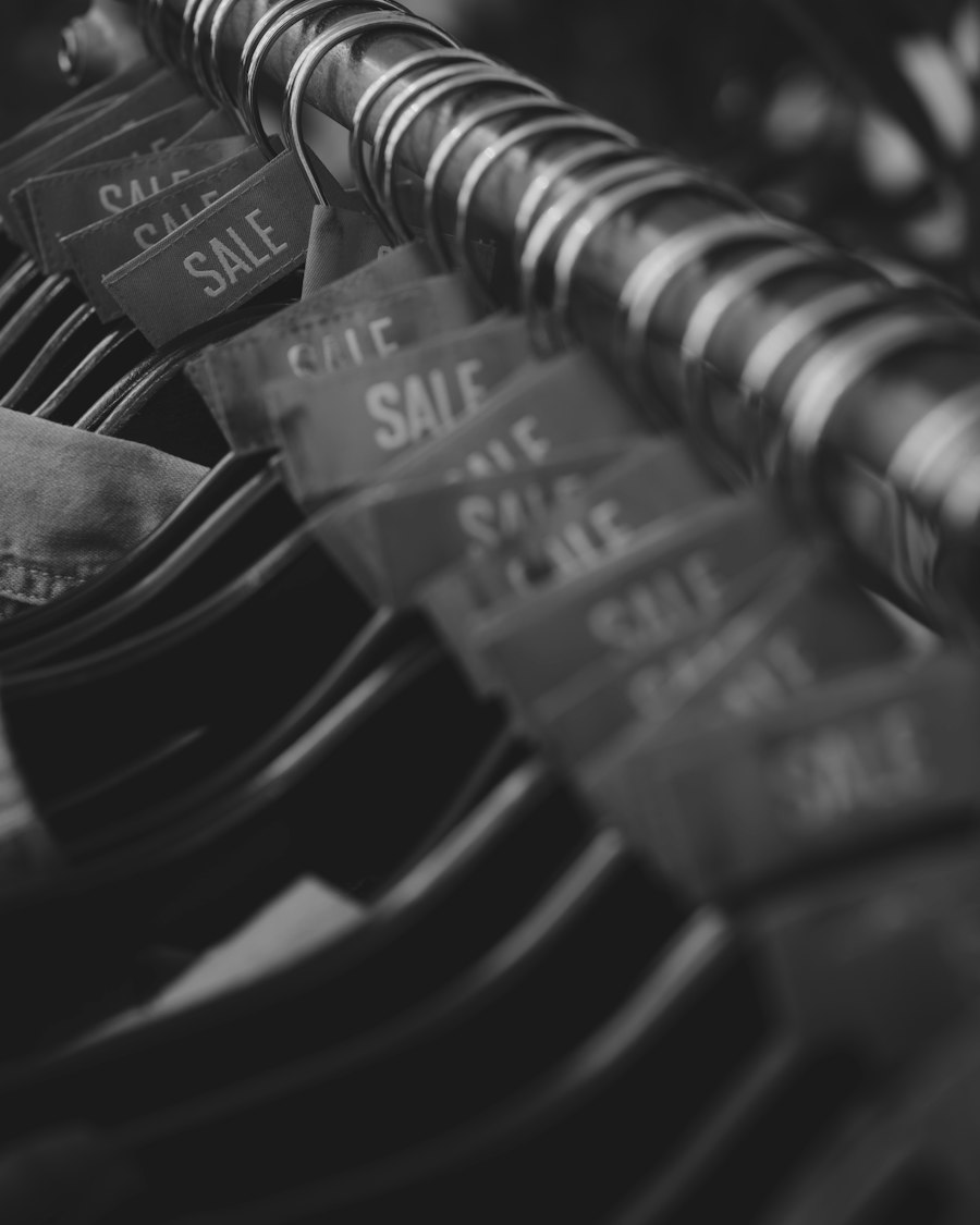 Rows of SALE tags on hangers along a clothing rail